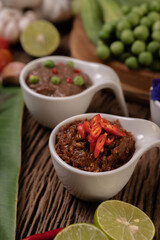 Red Eye Chili Paste with Lemon and Chili on Wooden Floor