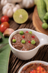 Nam phrik kapi  with Chili and Lemon on wooden floor.