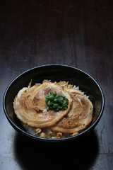 Asian ramen noodle soup with chicken on black concrete background. Top view, copy space for text