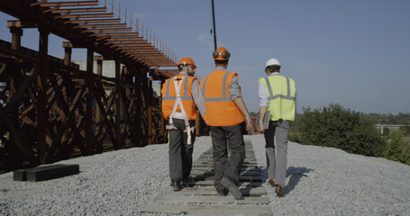 Team of engineers walking on construction site