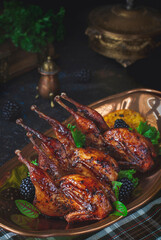 Roasted quails with oranges and berries