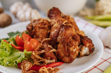 Fried chicken leg with tomato, chili, fried onion, lettuce, corn, and needle mushroom.