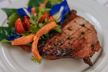 Pork Steak with Tomato, Carrot, Red Onion, Peppermint, Butterfly Pea Flower, and Lime.
