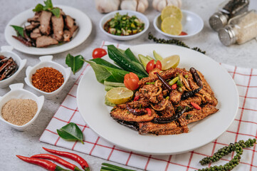 Pork Nam Tok with fried chili, tomato, lime, cucumber, and fresh pepper.