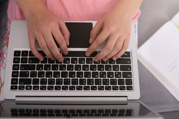 Teenage girl with laptop having online school class at home. Home Schooling. Learning from home in coronavirus times.