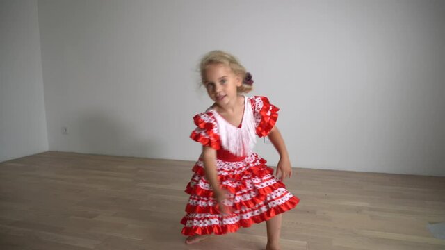 funny girl dancing at home. Dancer child in red dress move. Gimbal motion