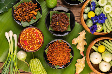 Different types of chili sauce in a cup with ingredients to make