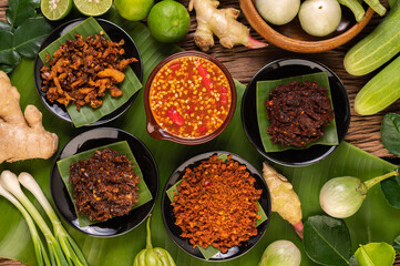 Different types of chili sauce in a cup with ingredients to make