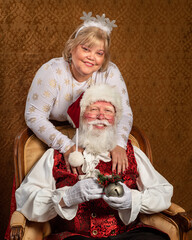 Happy Santa Claus with Mrs. Claus family portrait in studio