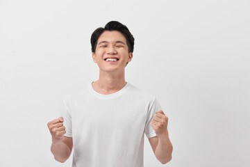 Close-up daylight portrait of young smiling handsome man isolated on gray background