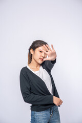 Girl in white stretch jeans and do hand prohibition sign on white background.