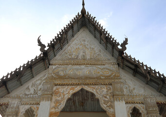 Old Thai temple gable designed - by beautiful old builders and lettered - indicating the year - built in the countryside of Thailand.