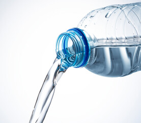 Water from a plastic bottle on a white background