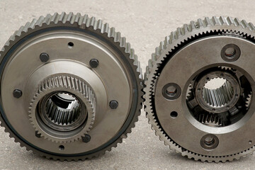       Two large steel gears assembled with planetary gear shown in engagement.