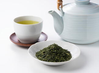 Green tea and tea leaves on a white background