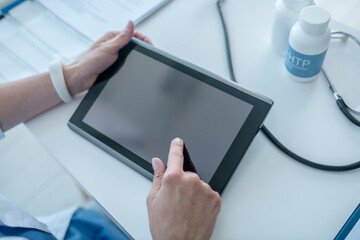 Human hands touching sensor screen on a tablet