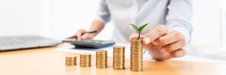 Saving money and investment concept, Business accountant woman stacking coins into increasing...