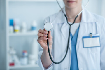 Doctor in a white lab coat holding a stethoscope
