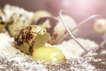 quail eggs in flour on a wooden background