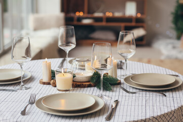 Beautiful table setting with Christmas decorations in living room