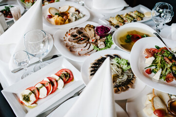 A table with cutlery, food, wine for people to celebrate. Concept of dining lunch. Business Lunch...
