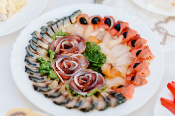 Dish. Red caviar and fish. Tuna. White plate on white table. Food. Fish eggs olives. Holiday food. Wedding day.
