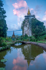 View of the temple gate and golden pagoda at Thailand.
