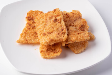 Rice cracker with flossy pork in a plate on a white background