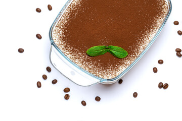 Traditional Italian Tiramisu dessert in glass baking dish and coffee beans isolated on white