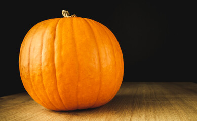 Small pumpkin on a wooden table.