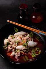 Yentafo in a black bowl. Dark tone picture.