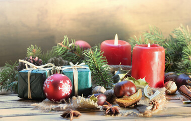 traditional christmas decoration on wooden background with candles and gifts