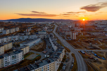 Beautiful sunrise over the city of Magadan. Morning aerial view of a Russian city in the Far East in Asia. Top view of buildings and streets. Magadan, Magadan region, Siberia, Far East of Russia.