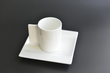 White empty cup of coffee isolated on black background