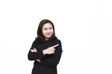 Portrait of Asian young happy woman smiling and pointing to presenting something on her side, with copy space