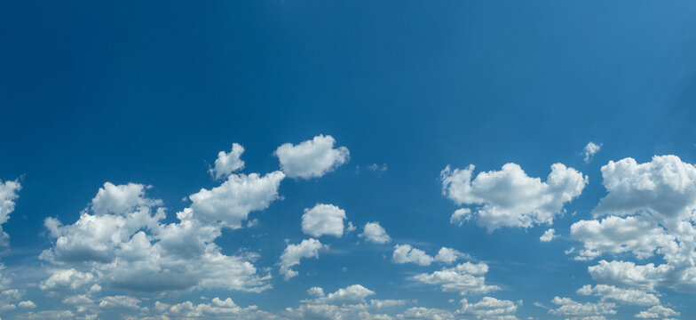 Some light cumuliform clouds in the clean blue sky.