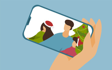Christmas online greetings. Online communication with family. Parting on holidays. Quarantine. Woman's hand holds a smartphone. There are two children and a dad on the phone.
