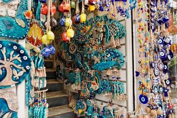 Bodrum, Turkey - August, 2020: souvenirs with evil eyes, masks, lanterns at the local market....