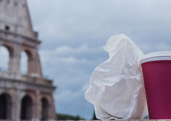 Paper coffee cup take away  on background of Colosseum 