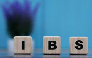 IBS - word on cubes on a blue background with lavender