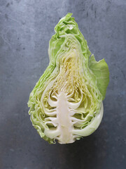conical cabbage with cureld leaves split in two halves