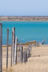 view on coastline divided by a fence