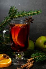 selective focus, hot drink, warmed red wine with fruit from oranges and apples, with spices of...