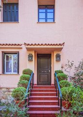 contemporary house entrance ceramic covered stairs and green door, Athens Greece