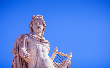Athens Greece, Apollo ancient god of poetry and music marble statue on plain background, space for your text