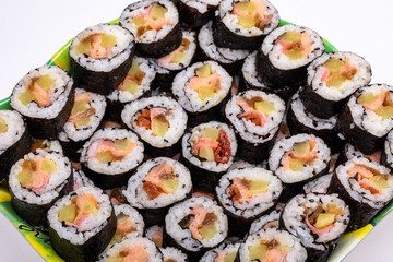 Top view of stack of Japanese sushi maki roll plate. Served in Japanese bar restaurant with chopstick