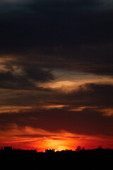 The reddish colors of the sun reflected in the clouds at a sunset in Madrid. Spain