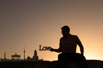 man in front of berlin city skyline in germany