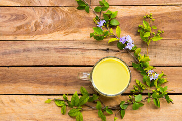 herbal healthy drinks hot green tea ,milks for health care with leaf arrangement flat lay style on background wooden