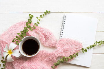 hot coffee espresso with knitting wool scarf of lifestyle woman relax and notebook ,white flowers...